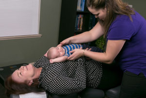 Relief-chiropractic-care-baby-on-mom-chest-Gardner-Chiropractic-Family-and-Wellness-Center